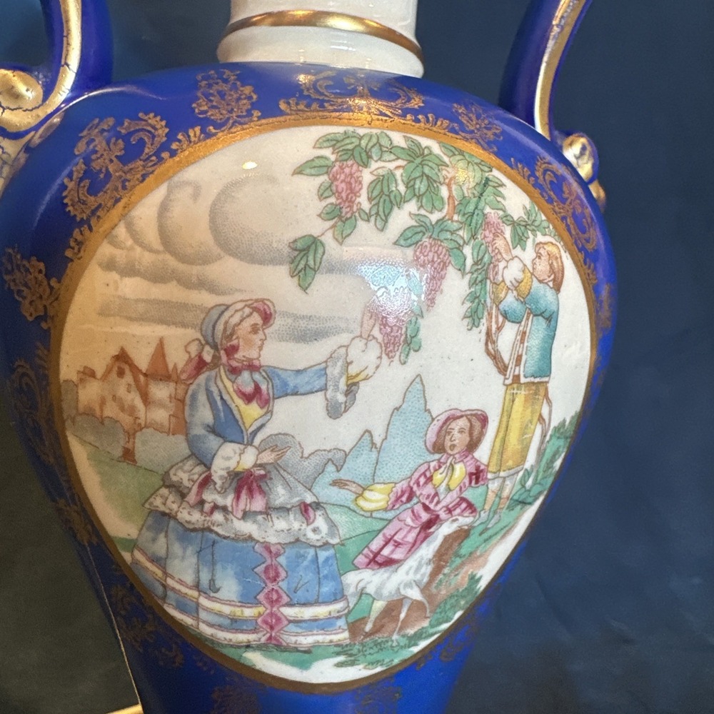Antique porcelain‎ urn lamp with grape-picking scene.